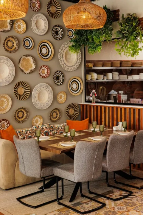 Nairi dining room with woven plate wall